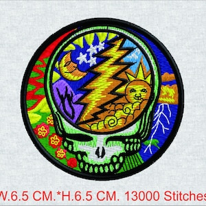 May include: Embroidered patch featuring a colorful skull design with a lightning bolt, sun, moon, and stars. The patch is round, with a black border and measures 6.5 cm in width and height.