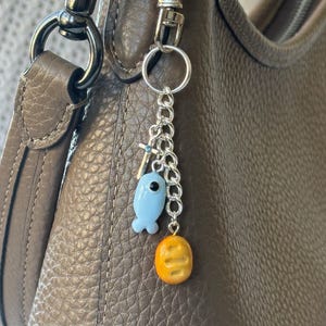 Llavero artesanal de Jesús alimentando a 5000, colgante para bolso de panes de pescado de arcilla