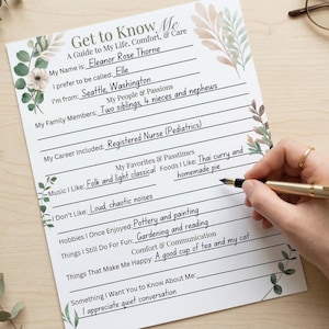 May include: A personalized "Get to Know Me" worksheet with floral accents. The sheet includes prompts for personal details, hobbies, and preferences. A hand with a gold pen is writing on the sheet. The text includes "Eleanor Rose Thorne" and "Seattle, Washington".