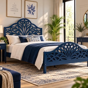 May include: A dark blue wooden bed frame featuring an intricate, open-work fan-shaped design on both the headboard and footboard. The bed is dressed with white linens, a dark blue throw blanket, and decorative pillows with blue and white patterns.
