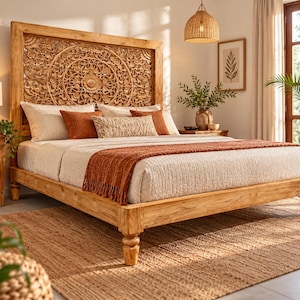 May include: A wooden bed frame featuring a tall headboard with intricate hand-carved floral patterns. The bed is dressed with white bedding, a textured rust-colored throw blanket, and several decorative pillows in shades of white and rust.