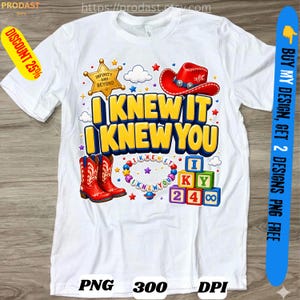 May include: A white t-shirt featuring a graphic print with the text I KNEW IT I KNEW YOU in yellow letters. The design includes a gold sheriff star, a red cowboy hat, red cowboy boots, a colorful beaded bracelet, and stacked alphabet blocks.