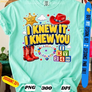 May include: A light mint green t-shirt featuring a graphic print with the text I KNEW IT I KNEW YOU, a gold sheriff star badge labeled INFINITY AND BEYOND, a red cowboy boot, a colorful beaded bracelet, and stacked alphabet blocks with numbers.