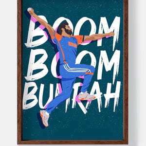 May include: A framed illustration featuring a cricket player in a blue and orange uniform, mid-action. The words "BOOM BOOM BUMRAH" are written in white brushstrokes. The artwork is set against a teal background.
