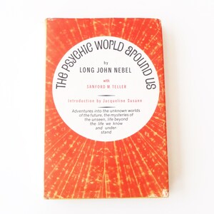 May include: The Psychic World Around Us book cover with a red background and a circular design featuring the title in black text. The book is by Long John Nebel with Sanford M. Teller and an introduction by Jacqueline Susann.