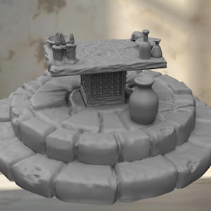 May include: A gray, tiered platform with a table and various decorative items. The table has a pentagram design and is surrounded by small bottles and a vase. The Magic Cave Studio logo is in the upper left corner.