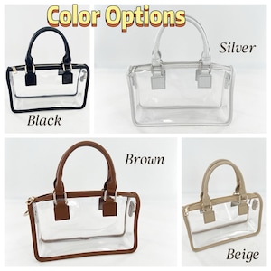 May include: Clear tote bags with various handle and trim colors: black, silver, brown, and beige. Each bag has a rectangular shape with a top handle and a zippered closure. The text "Color Options" is at the top of the image, with the color names below each bag.