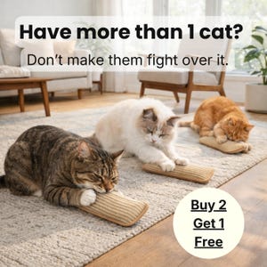 May include: Three cats, tabby, white, and ginger, rest on a rug, each with a small, rectangular scratching pad. The image includes the text "Have more than 1 cat? Don't make them fight over it." and "Buy 2 Get 1 Free."