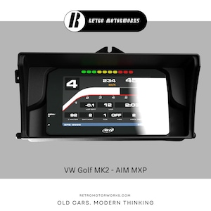 May include: Black digital dashboard with a display showing speed, lap times, and other data. The dashboard has a black frame and the text "VW Golf MK2 - AIM MXP". The Retro Motorworks logo is at the top.