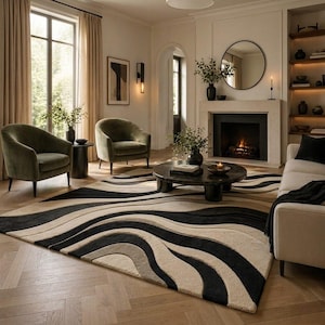 May include: A living room scene featuring a large area rug with a wave pattern in black, beige, and gray. Two olive green armchairs, a round coffee table, and a fireplace with a mirror above it complete the cozy, modern interior.