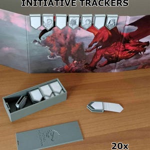 May include: A set of gray initiative trackers with white inserts, displayed on a game screen featuring a red dragon. The set includes a rectangular storage box with a lid labeled VOXEL HORSEMAN, and twenty individual trackers for tabletop gaming.