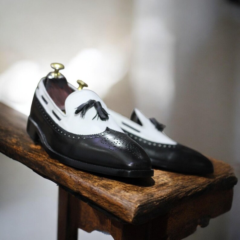 Close-up of tassel detailing and leather stitching, emphasizing handmade craftsmanship.