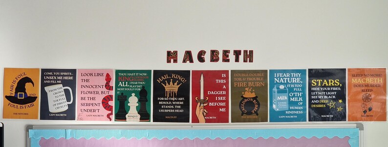 May include: A collection of colorful posters with quotes from Shakespeare's Macbeth, displayed on a white wall. The word "Macbeth" is spelled out in decorative letters above the posters. Each poster features unique designs and text, with a variety of colors.
