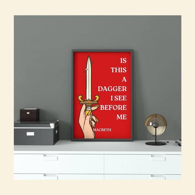 May include: A framed art print with a red background features a hand holding a dagger. The text reads "IS THIS A DAGGER I SEE BEFORE ME" with "MACBETH" below. The print is in a black frame.