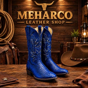 May include: A pair of vibrant blue cowboy boots featuring a textured snakeskin-like pattern and intricate white stitching details on the shaft. The boots have a pointed toe, a stacked heel, and a tall silhouette, standing on a wooden surface.