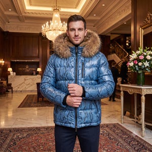 May include: A blue puffer jacket with a black snakeskin pattern, featuring a large brown fur-trimmed hood, a central black zipper, and black ribbed cuffs. The jacket has a quilted texture and a vertical zippered pocket on the left chest area.