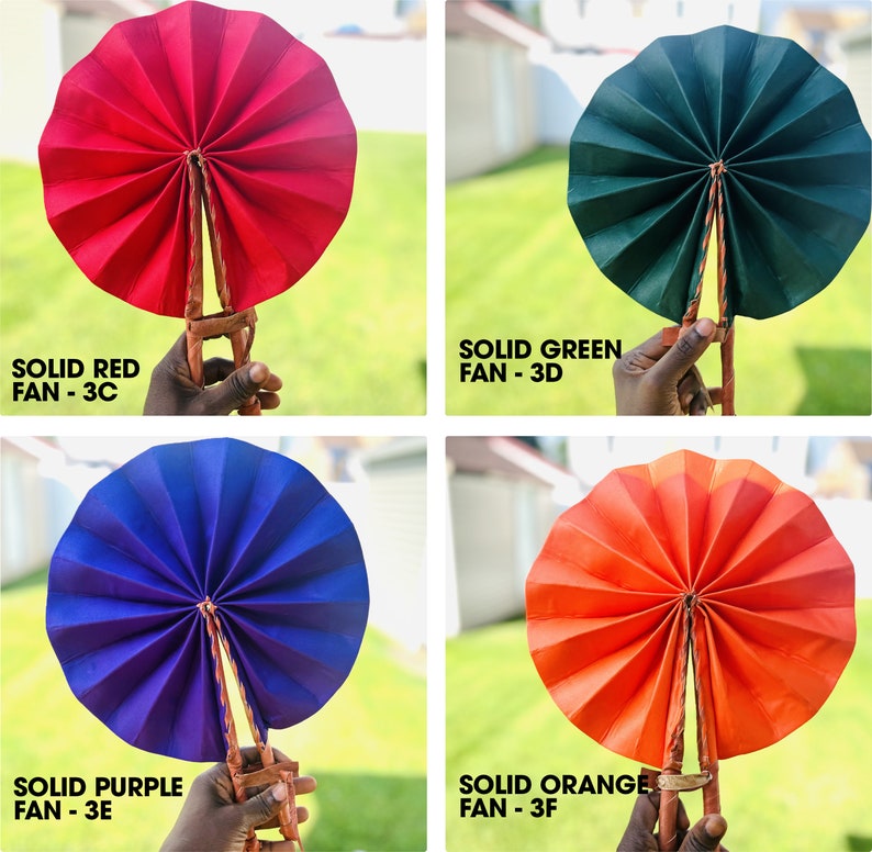 May include: Four hand fans, each a different solid color: red, green, purple, and orange. The fans are made of paper and have a wooden handle.