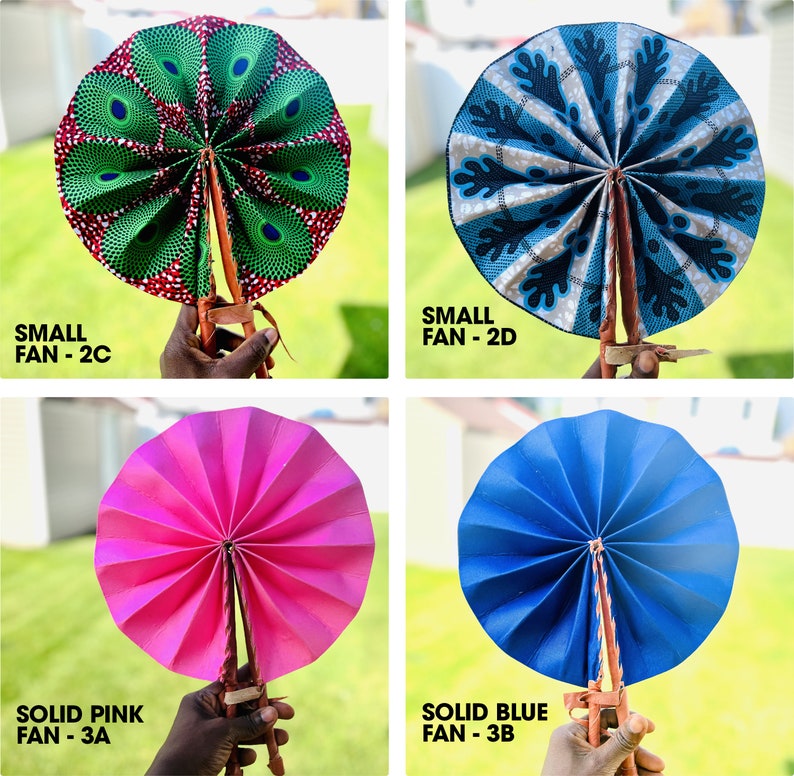 May include: Four hand fans, two small and two large. The small fans are patterned, one with a green and red design and the other with a blue and white design. The large fans are solid colors, one pink and one blue.