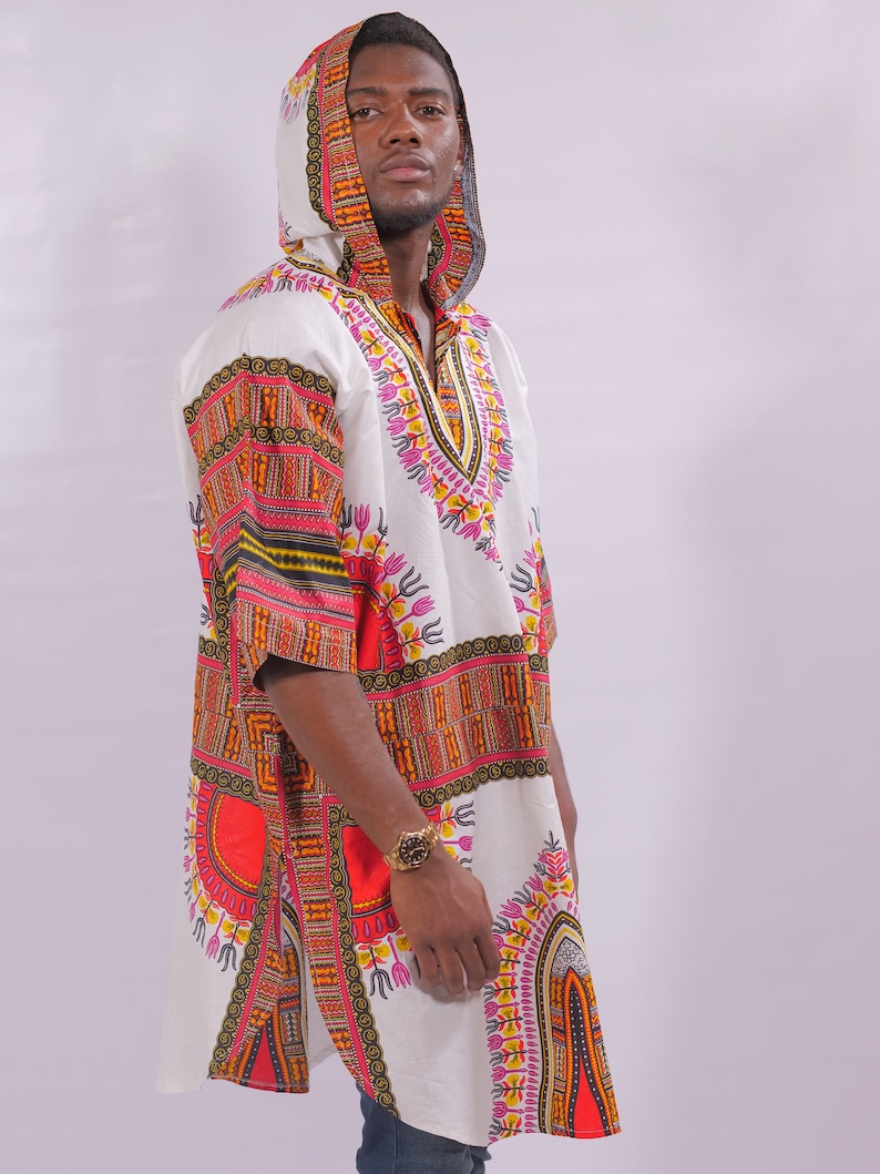 May include: A white hooded tunic with a colorful geometric pattern in shades of red, orange, yellow, green, and pink. The tunic has a V-neck and a long, flowing hem.