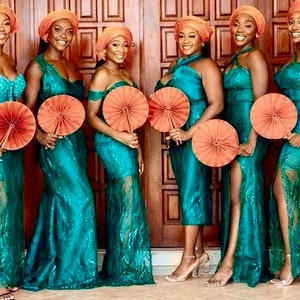 May include: Six bridesmaids wearing teal sequined dresses with orange headbands and holding orange hand fans.
