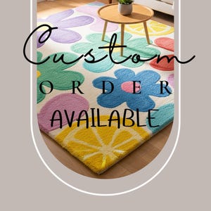 May include: A colorful floral rug with large flower and lemon slice designs in shades of blue, green, pink, yellow, and purple. The rug has the text "Custom Order Available" in black script.