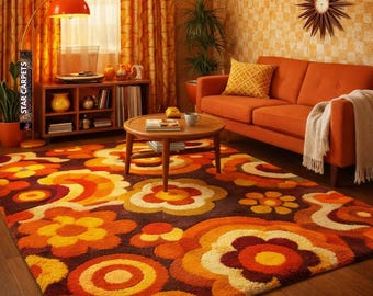 May include: A retro-style living room featuring a large area rug with a floral pattern in shades of orange, yellow, and brown. The room includes an orange sofa, curtains, and a floor lamp, creating a cohesive 1970s aesthetic.