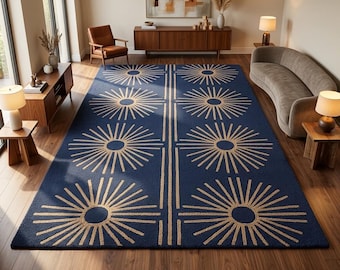 May include: A large rectangular area rug featuring a deep navy blue background with a repeating pattern of light beige sunburst motifs arranged in two vertical columns, separated by a central double line running the length of the rug.