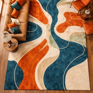 May include: A large rectangular area rug featuring a bold, abstract pattern of flowing, organic shapes in vibrant shades of deep teal, burnt orange, and cream. The design consists of sweeping, curved lines that create a dynamic, layered effect.