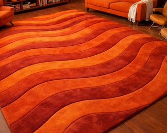 May include: A large, rectangular rug with a wavy pattern in shades of orange and red. The rug is the focal point of a retro-style living room, complementing the orange sofa and wooden furniture. The rug's design adds a dynamic element to the room's decor.