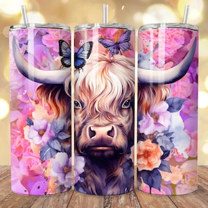 May include: Three stainless steel tumblers with a floral and Highland cow design. The design features a cow's face with large horns, butterflies, and pink and purple flowers. Each tumbler has a silver straw.