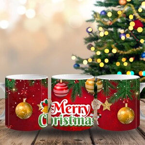 May include: White ceramic Christmas mug with a red background and festive decorations. The mug features gold and red ornaments, green pine branches, and the words "Merry Christmas" in white and green.