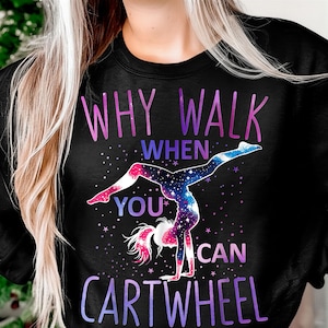 May include: Black sweatshirt with the text "WHY WALK WHEN YOU CAN CARTWHEEL" in purple and blue. A gymnast doing a cartwheel is in the center, with a galaxy design. The gymnast's hair and feet are pink.