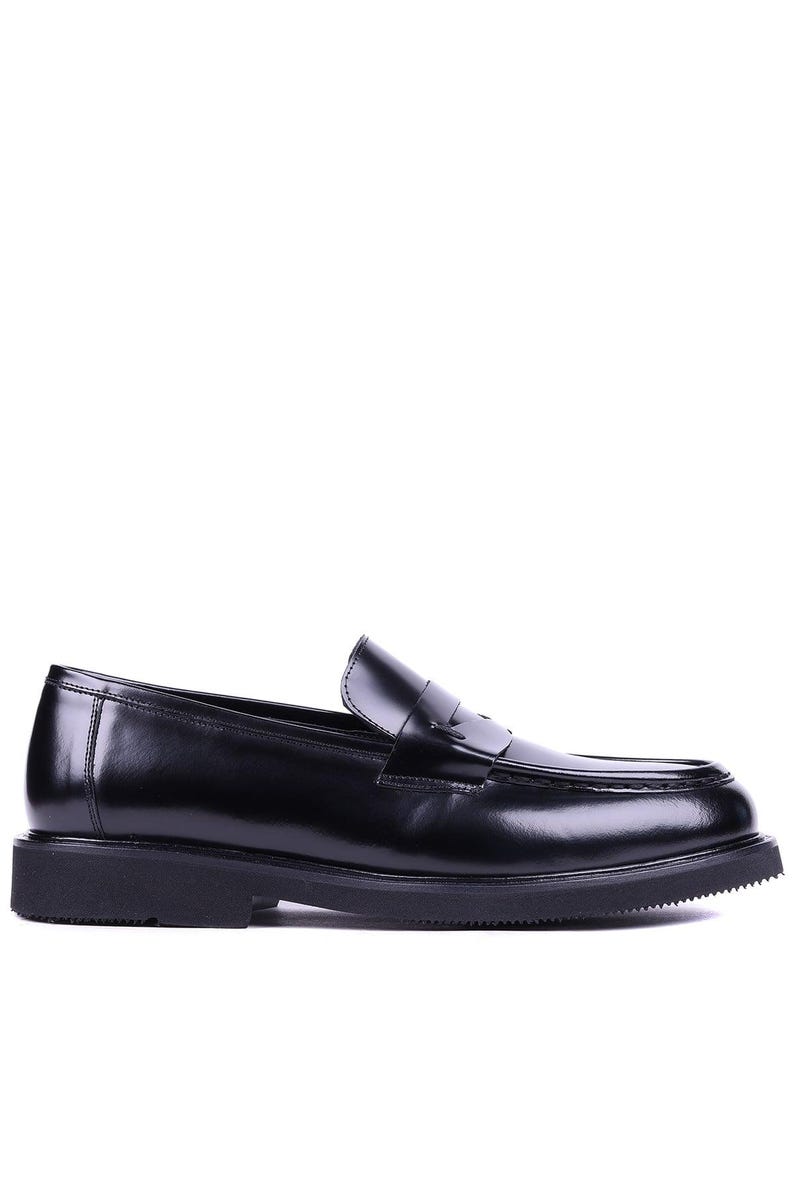 May include: A pair of black leather penny loafers. The shoes have a classic design with a rounded toe, a strap across the vamp, and a thick, textured sole. The loafers are made of shiny, polished leather.