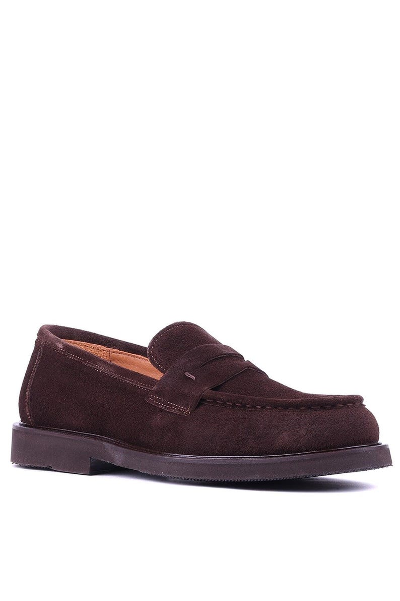 May include: A single brown suede loafer with a rounded toe and a low, dark brown sole. The shoe features a penny strap detail across the vamp and a stitched design. The shoe is designed for comfort and style.