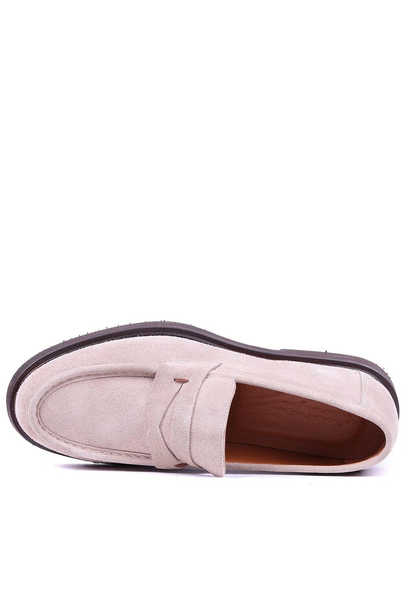 May include: A single light beige suede loafer with a dark brown sole. The shoe features a classic penny loafer design with a strap across the vamp. The sole is approximately 1 inch thick.
