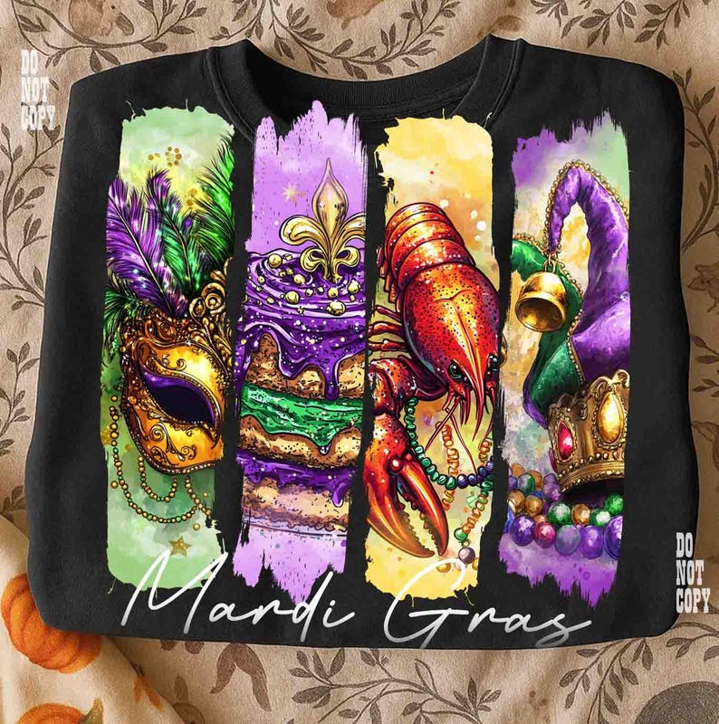 May include: Black sweatshirt featuring a colorful Mardi Gras design. The design includes a mask, cake, crawfish, and a jester's hat. The words "Mardi Gras" are written in white script across the bottom of the design.