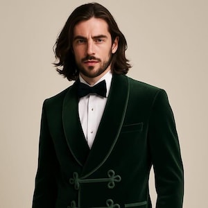 May include: A dark green velvet tuxedo jacket with a shawl collar and decorative frog closures. The jacket is paired with a white dress shirt and a black bow tie. The formal wear is suitable for special occasions.