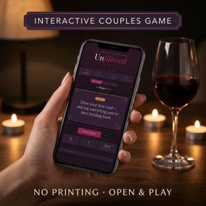 May include: A smartphone displaying the "Unfiltered" couples game interface, held near a wine glass filled with red wine. The screen shows a prompt to share feelings. The text "INTERACTIVE COUPLES GAME" and "NO PRINTING • OPEN & PLAY" are visible.