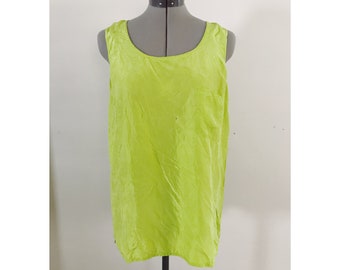 May include: A sleeveless, lime green top with a scoop neckline is displayed on a gray dress form. The fabric has a slightly wrinkled texture. The top is a solid color and appears to be made of a lightweight material.