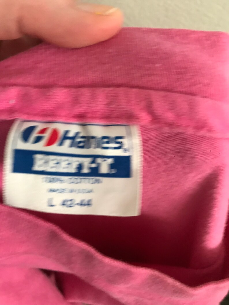 May include: Pink Hanes Beefy-T shirt tag with the text "Hanes Beefy-T 100% Cotton Made in USA L 42-44"