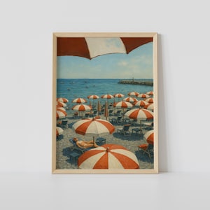 May include: Framed print depicting a beach with many red and white striped parasols. People are relaxing on sun loungers under the parasols. The sea and a pier are visible in the background. The artwork has a vintage, painted style.