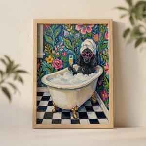 May include: Framed art print depicting a black poodle in a clawfoot bathtub with bubbles, wearing heart-shaped sunglasses and a towel, holding a champagne glass. The background shows floral wallpaper and a black and white chequered floor.