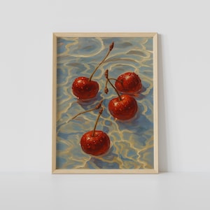 May include: A framed art print showing four ripe red cherries with water droplets, floating in light blue and gold-toned water. The cherries are attached to thin stems. The artwork is in a wooden frame.