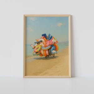 May include: A framed painting depicts a beach scene with a cart overflowing with colorful inflatable pool floats. The floats include unicorns, donuts, and rings, set against a backdrop of a sandy beach, ocean, and blue sky.