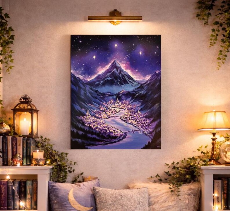 May include: A large, vertical painting depicts a nighttime landscape with a mountain range under a starry sky. A river flows through a valley with a city illuminated in purple and white lights. The artwork is mounted on a wall above a cozy seating area.