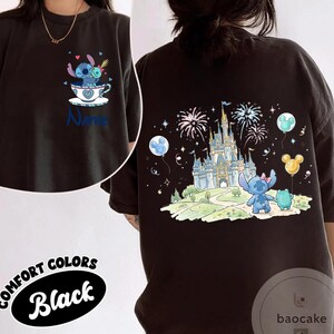 May include: Black Comfort Colors t-shirt featuring a cartoon Stitch design. The front shows Stitch in a teacup, the back has Stitch, a frog, and a castle with fireworks. The shirt has the word "Name" on the front.