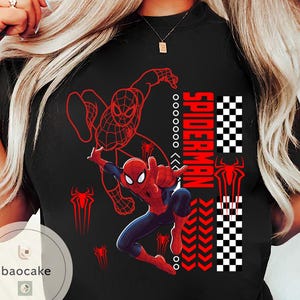 May include: Black t-shirt featuring a vibrant Spider-Man graphic. The design includes a dynamic illustration of Spider-Man in action, the word "SPIDERMAN" in red, and a checkered pattern. Red spider symbols are also present.