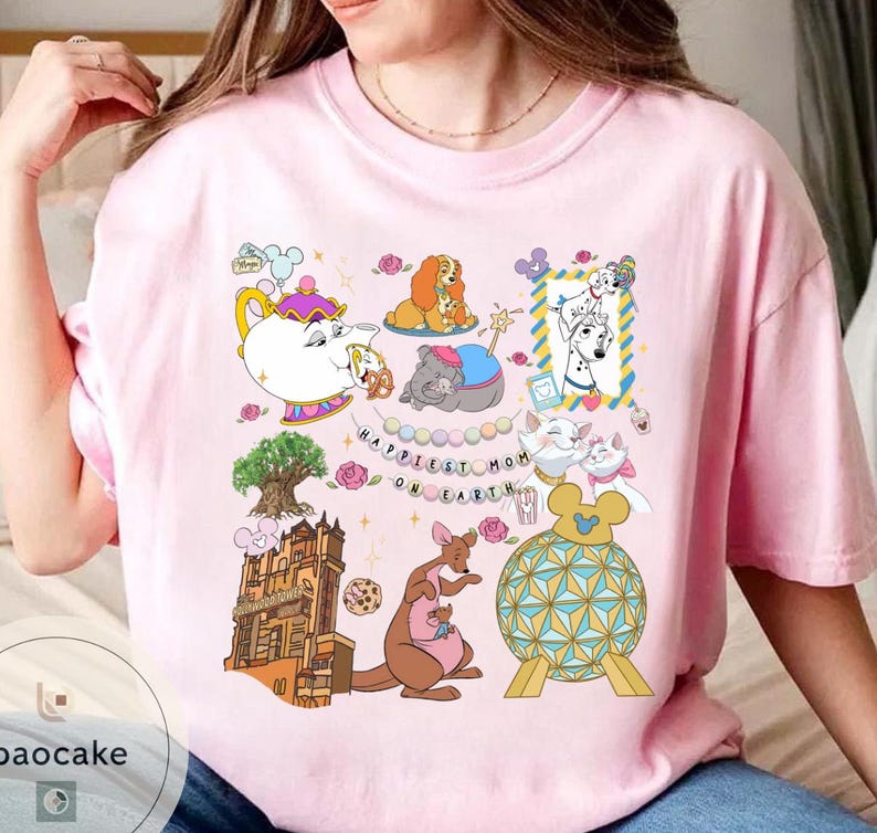 May include: Pink t-shirt featuring a colorful graphic with cartoon characters, including a teapot, dogs, cats, and a kangaroo. The text "Happiest Mom on Earth" is also included in the design. The shirt is a casual, everyday wear item.