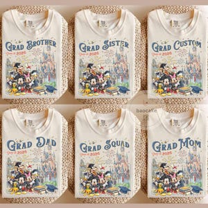 May include: Cream-coloured t-shirts with graduation-themed designs. Each shirt features a Disney-themed graphic with the text "Grad Brother," "Grad Sister," "Grad Custom," "Grad Dad," "Grad Squad," and "Grad Mom," with "Class of 2026."