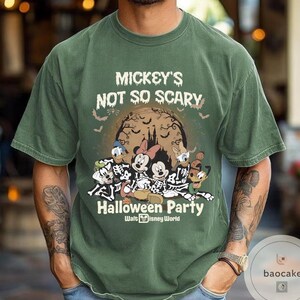 May include: Green t-shirt with the text "Mickey's Not So Scary Halloween Party" and a graphic of Disney characters in skeleton costumes. The graphic includes Mickey, Minnie, Donald, and Goofy in front of a full moon. Bats are flying around the moon.